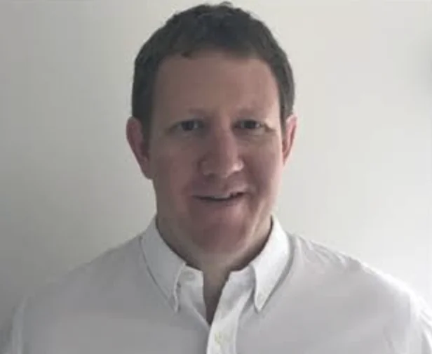 Portrait of David Viles, Roamler's Chief Revenue Officer, wearing a white shirt against a plain background
